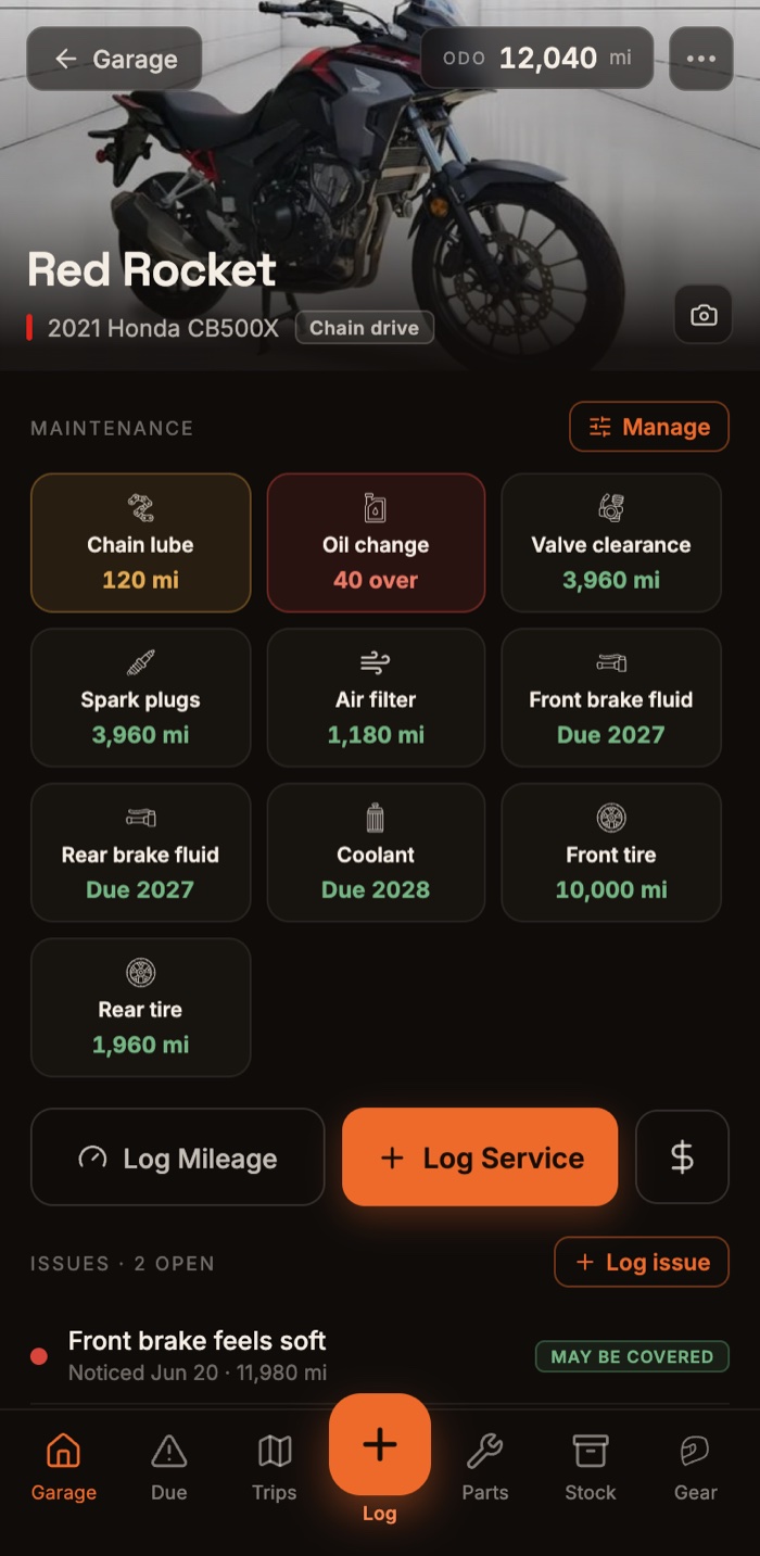 The bike detail screen in the Moto Garage app: Red Rocket, a 2021 Honda CB500X, with its color-coded maintenance countdown grid, Log Service button, and open issues